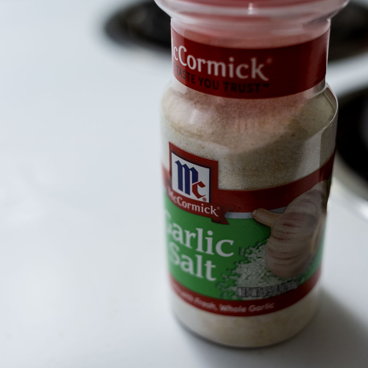 A garlic jar lies in focus within the depth-of-field while the background is left blurry and out of focus drawing attention to the subject.