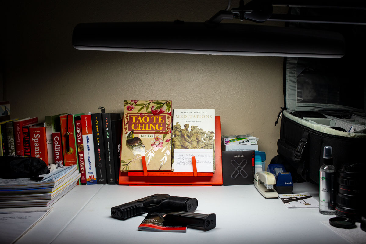 This shows how the photograph of a Sig Sauer P320 with magazine and manual on a white background was made with only a single desklamp for a light source.